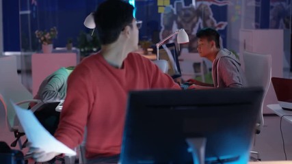  Video game development team collaborating in creative office