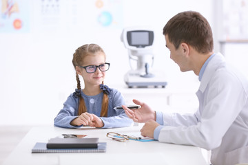 Wall Mural - Cute little girl in ophthalmologist's office