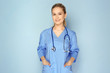 © Africa Studio - Young medical assistant with stethoscope on color background