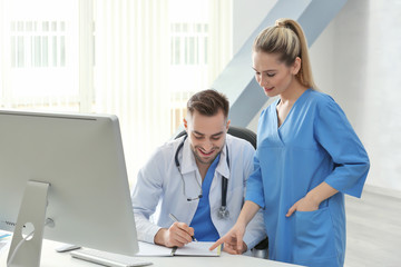 Poster - Doctor and medical assistant discussing issue in office