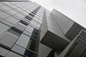 Looking up a modern high rise.