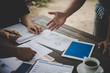 © Johnstocker - Group of business people analysis with marketing report graph, Young specialists are discussing business ideas for new digital start up project.