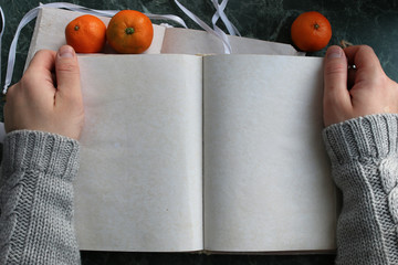 Canvas Print - pages opened vintage book on green marble countertop