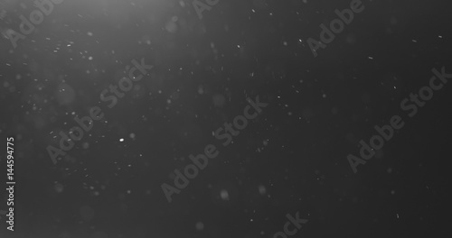 Cuadros en Lienzo dust particles fly in the air over black background with light leak, 4k photo