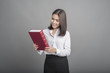 © tonefotografia - Beautiful teacher Woman holding book on grey background