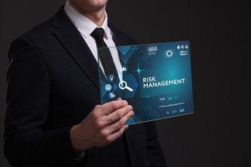 Business, Technology, Internet and network concept. Young businessman working on a virtual screen of the future and sees the inscription: Risk management