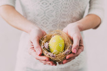 Woman Holding A Nest With Easter Eggs
