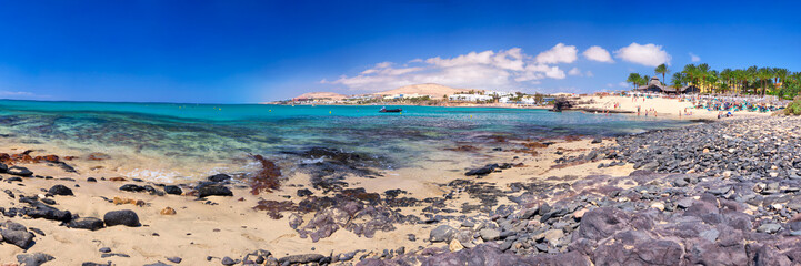 Wall Mural - View to Costa Calma sandy beach with vulcanic mountains in the background on Fuerteventura island, Canary Islands, Spain.