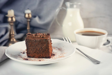 Plate with delicious cocoa brownie on table