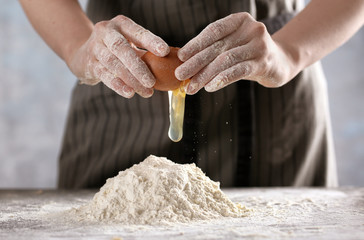 Canvas Print - Woman making dough for ravioli on table