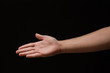 © haoka - right hand Extended male arm with open palm on a black background
