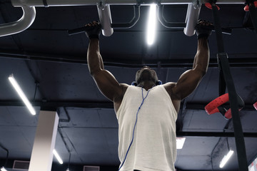 Wall Mural - black man doing exercises pull ups