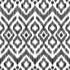 Wall Mural - Vector illustration of the black and white colored ikat ornamental seamless pattern. Chevron design. Scribble textured effect. Ethnic style.