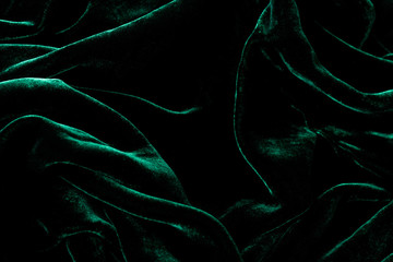 dark green velvet background. luxurious shiny material.