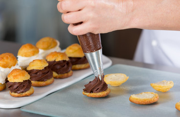 Chef decorating some profiteroles