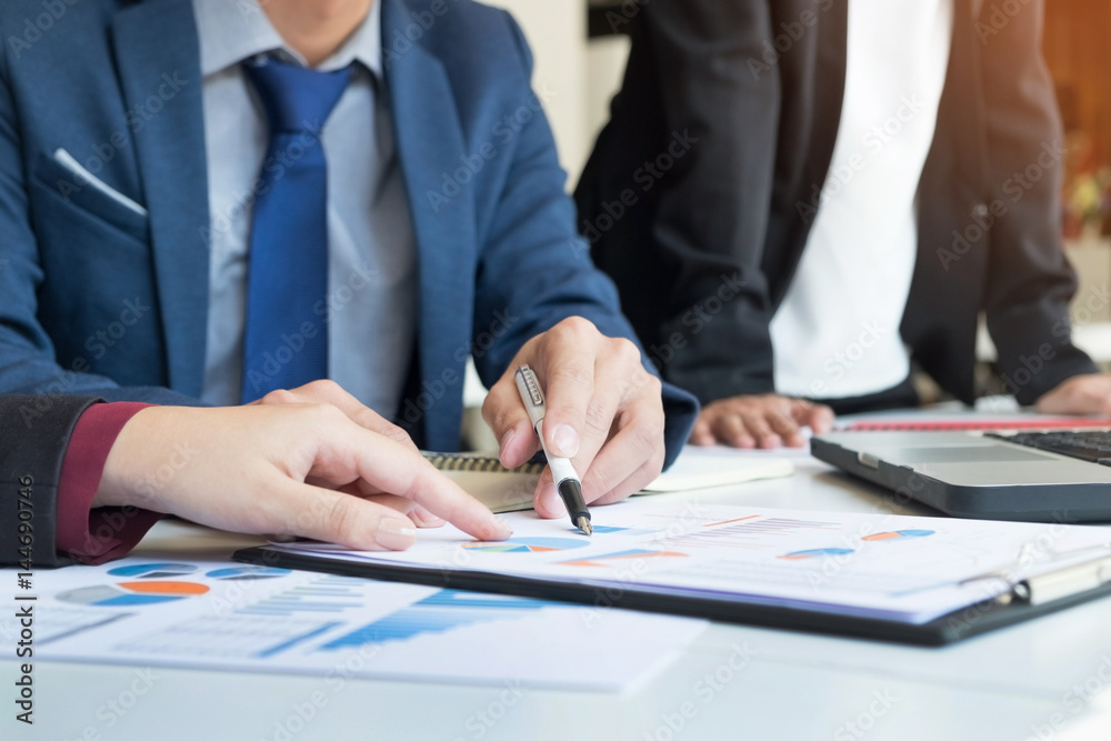 Team work process. young business managers crew working with new startup project. labtop on wood table, typing keyboard, texting message, analyse graph plans