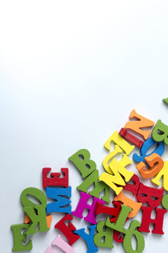 Wooden colored letters on a white background.