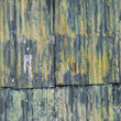 © ahavelaar - rusty corrugated iron doors of shed with green yellow paint