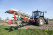 farmer ploughs filed with plough behind tractor near renswoude in the netherlands