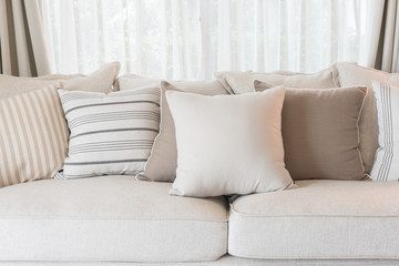 Poster - set of pillows on classic sofa in modern living room