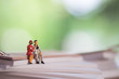© noppawan09 - Miniature people: the recruiter sitting on top of notebook for finding the candidates, recruitment process, HR, HRM, HRD concepts.