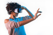 © kegfire - Pretty woman wearing VR goggles touching air