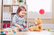 © Tierney - Happy toddler girl playing with her teddy bear