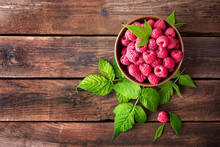 Fresh Raspberry With Leaves On Wooden Background