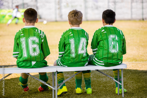 Kids Soccer Team Young Boys Reserve Players Sitting On Bench And