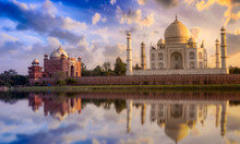 Taj Mahal With A Vibrant Sunset Sky On The Banks Of River Yamuna. Taj Mahal Is A White Marble Mausoleum Designated As A UNESCO World Heritage Site At Agra, India.