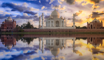 Fototapete - Taj Mahal sunset view from Mehtab Bagh on the banks of Yamuna river. Taj Mahal is a white marble mausoleum designated as a UNESCO World heritage site at Agra, India.