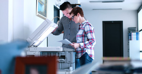 businesswoman with her assistant making copies of files