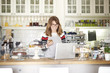 © sepy - Running her cafe with confidence. Shot of a happy coffee shop owner using mobile phone and text messaging while standing behind the counter in cafe. Small business.