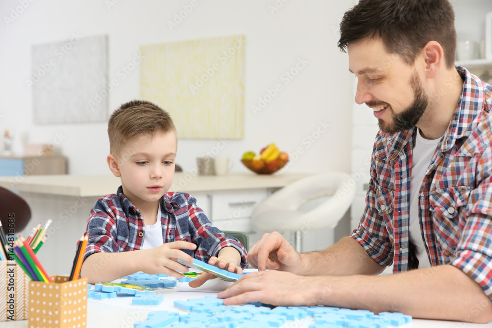 Father playing with his son at home