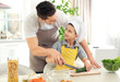 © Africa Studio - Dad and son cooking at home