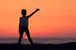 © Weston - A Silhouette Of A Child Playing Near The Beach At Sunset