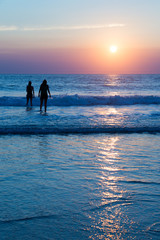 Wall Mural - silhouettes of people enjoying the sunset on the atlantic ocean, lacanau france