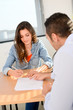 © W PRODUCTION - beautiful young woman in office with professional finance businessman buying contract signature
