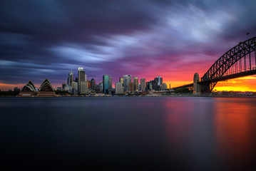 Fototapete - Sunset skyline of Sydney downtown  with Harbour Bridge, NSW, Australia