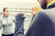 © Syda Productions - close up of woman with trainer working strike out