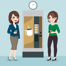 Two Beautiful Young Business Woman Team Having Coffee From Vending Machine On Office Break Time
