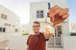© satura_ - Concept of housewarming, real estate, new home - Young man holding key of new house.