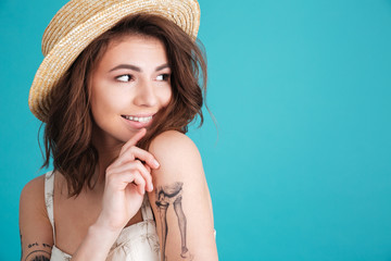 Wall Mural - Close up portrait of a smiley young girl in straw hat