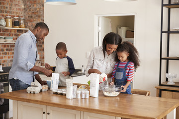 Wall Mural - Parents And Children Baking Cakes In Kitchen Together