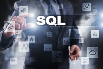 Businessman selecting sql on virtual screen.