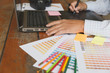 © 88studio - freelance graphic designer using digital tablet, computer, man working with color swatch catalog samples for selection - Creativity Editor Ideas Designer Concept