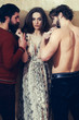 © Volodymyr - Pretty girl in arms of two bearded men