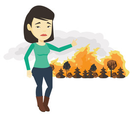 Canvas Print - Woman standing on the background of wildfire.