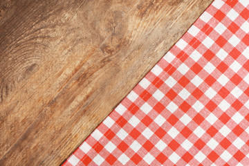 Wall Mural - Red checkered tablecloth on wooden background