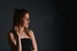 © muro - young woman with cigarette, smoking concept on black background